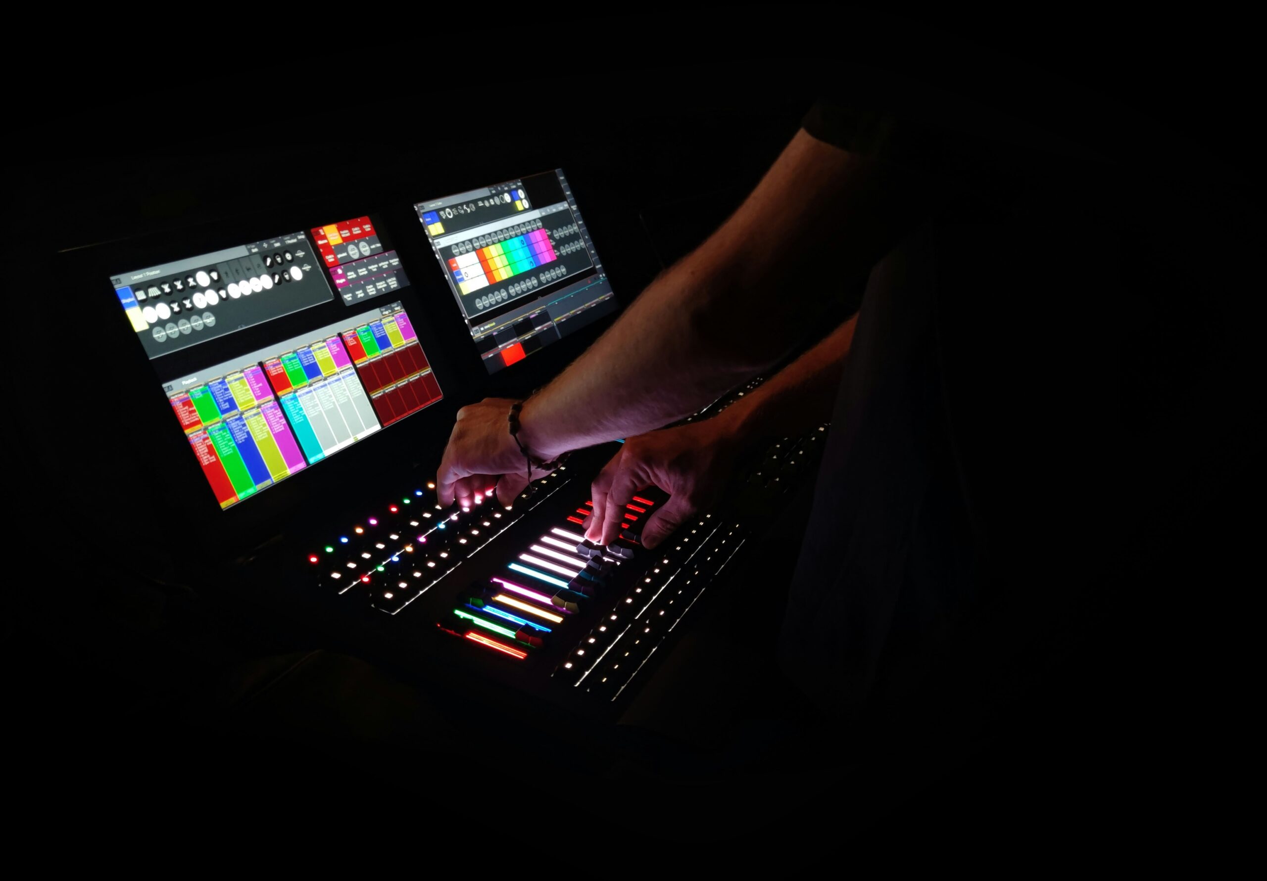 Audio mixing console with faders and knobs in a recording studio.